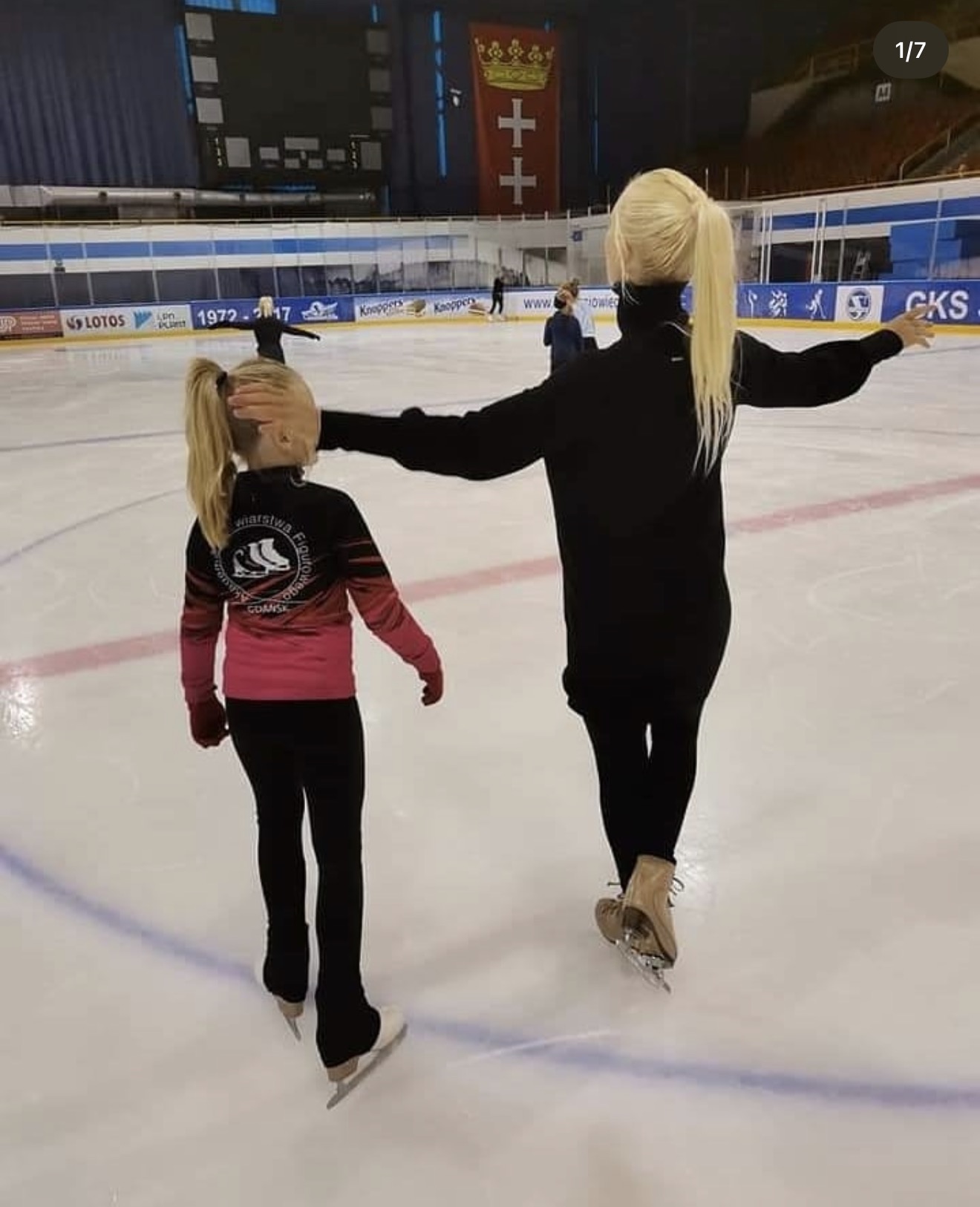 Natalia coaching a young figure skater on ice